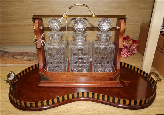An Edwardian inlaid mahogany tray and a mahogany three decanter tantalus